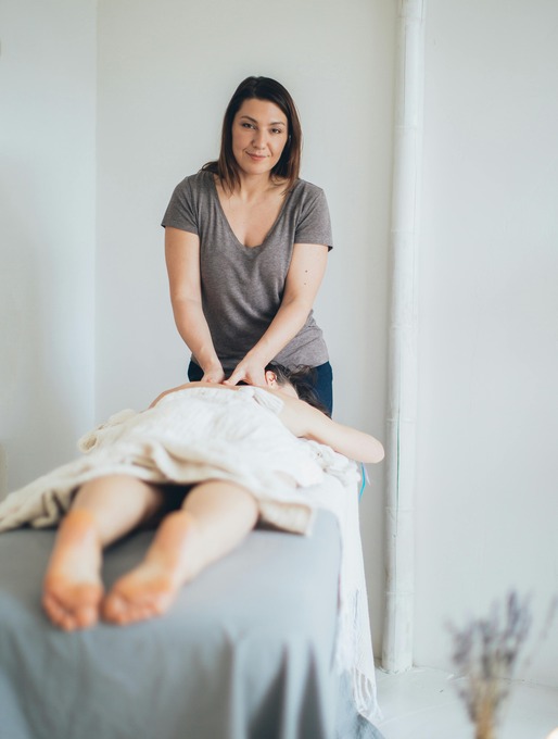 massage therapist giving a remote massage to woman on table